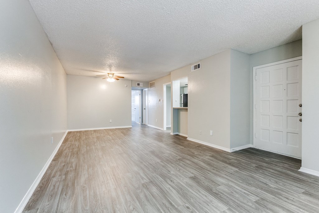 the spacious living room and dining room of an apartment at Falls on Clearwood Apartments, Richardson, TX, Texas