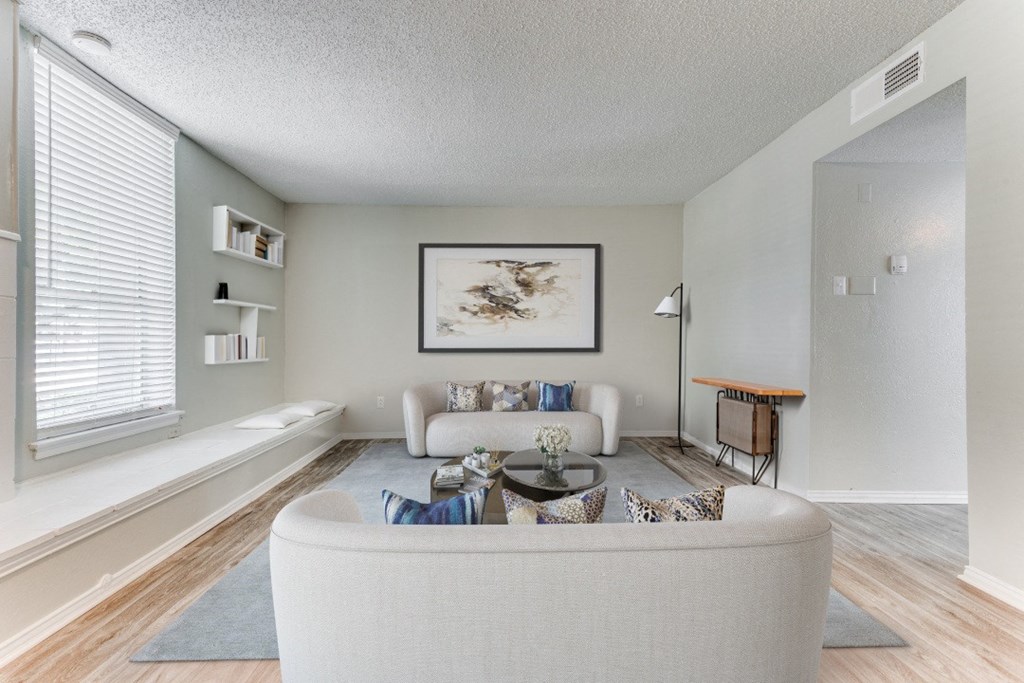 the living room of an apartment with a couch and a coffee table at Falls on Clearwood Apartments, Richardson, TX, Texas