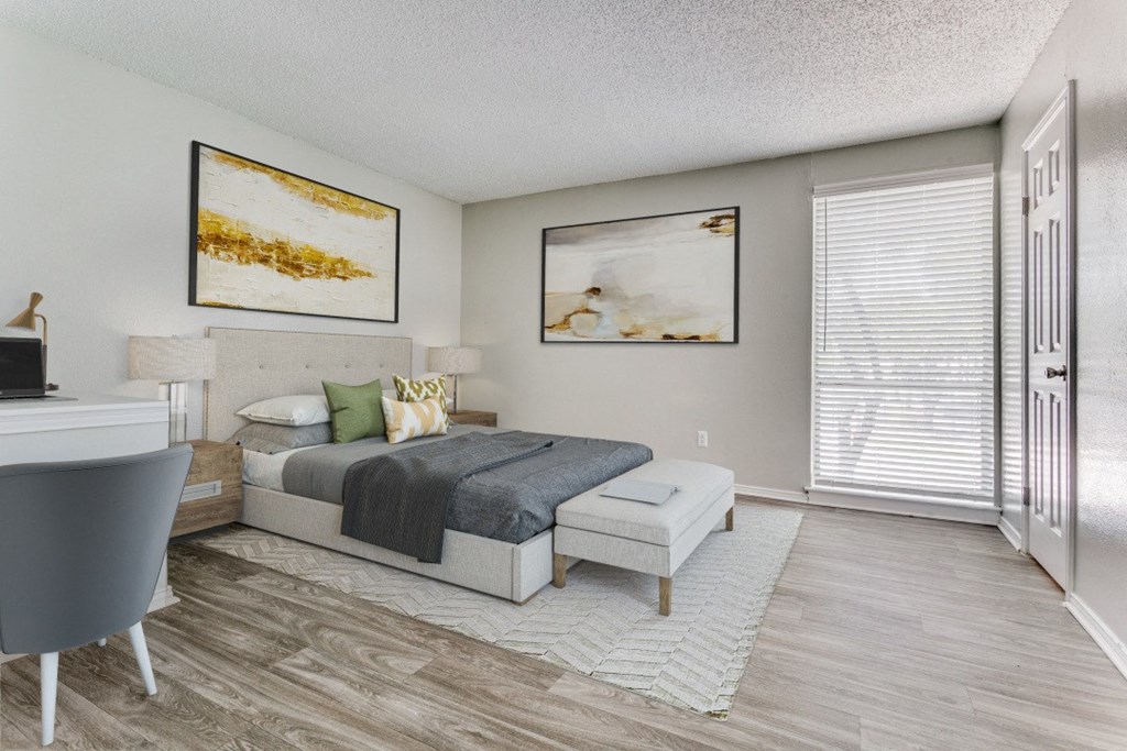 a bedroom with a bed and a desk and a window at Falls on Clearwood Apartments, Richardson, TX, Texas