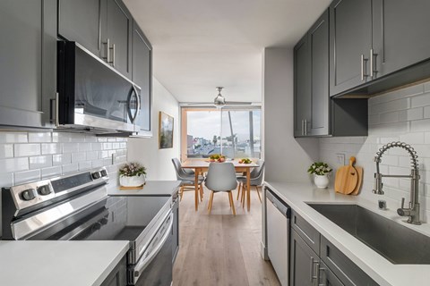 A modern kitchen with a dining table and chairs.