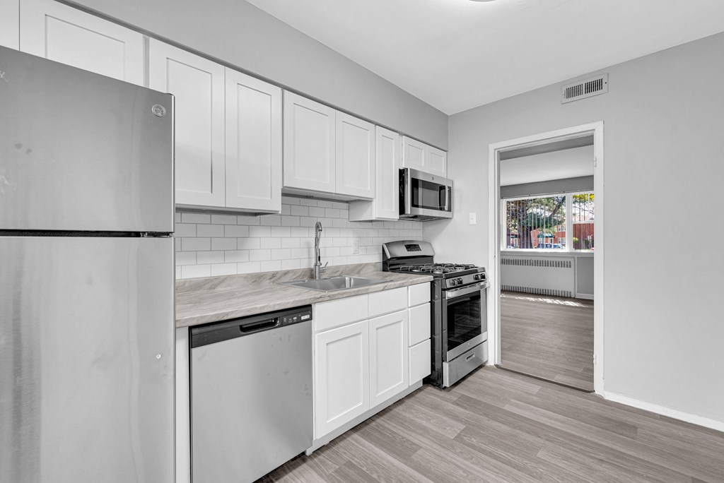 a kitchen with white cabinets and Refrigerator at Hampton Gardens, Missouri, 63139