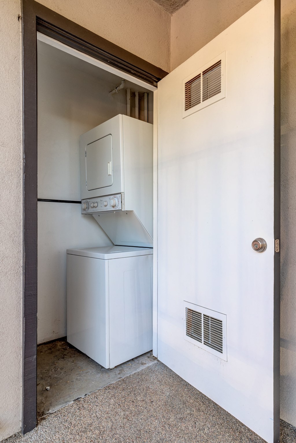 a white refrigerator and freezer in a room with a door