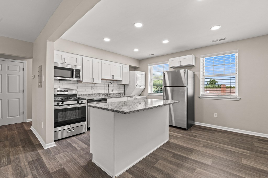a kitchen with a large island and stainless steel appliances at Hampton Gardens, Missouri