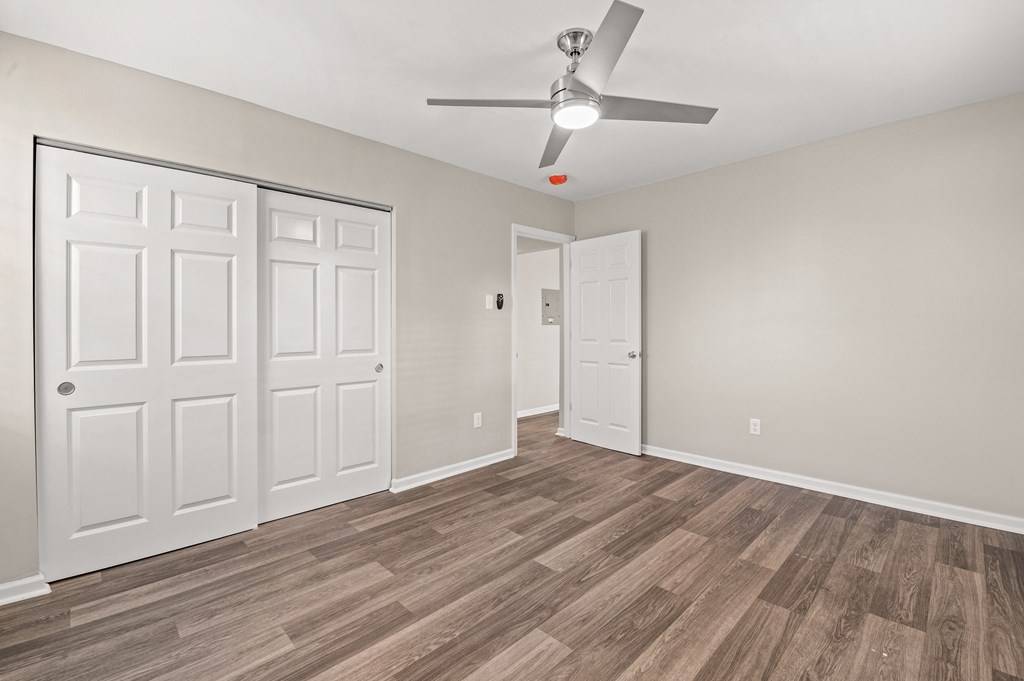 a bedroom with hardwood flooring and a ceiling fan at Hampton Gardens, Saint Louis, Missouri