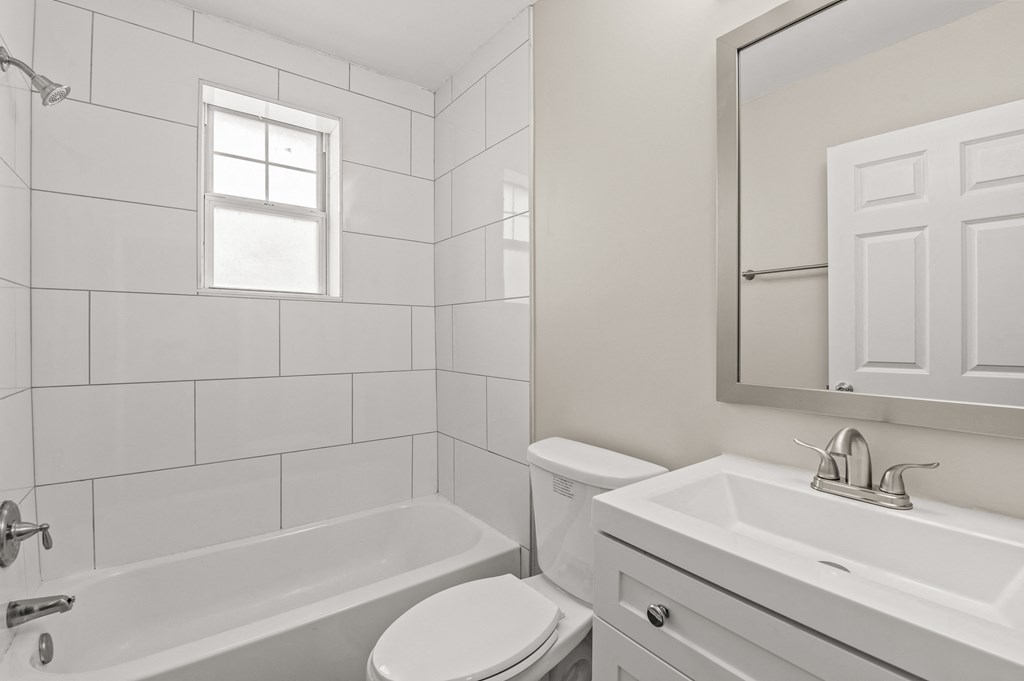 a bathroom with a white sink and toilet and a white bathtub at Hampton Gardens, Saint Louis, MO, 63139