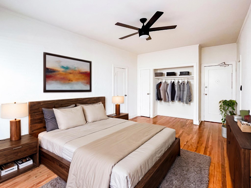 A bedroom with a large bed and a ceiling fan at Kenmore Park Apartments, Los Angeles, CA, 90004