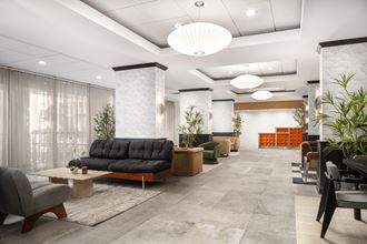 a lobby with couches and chairs and a table