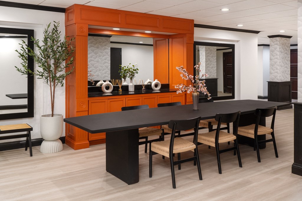 a large dining room with a black table and chairs at Vision on Lombard, Maryland, 21201