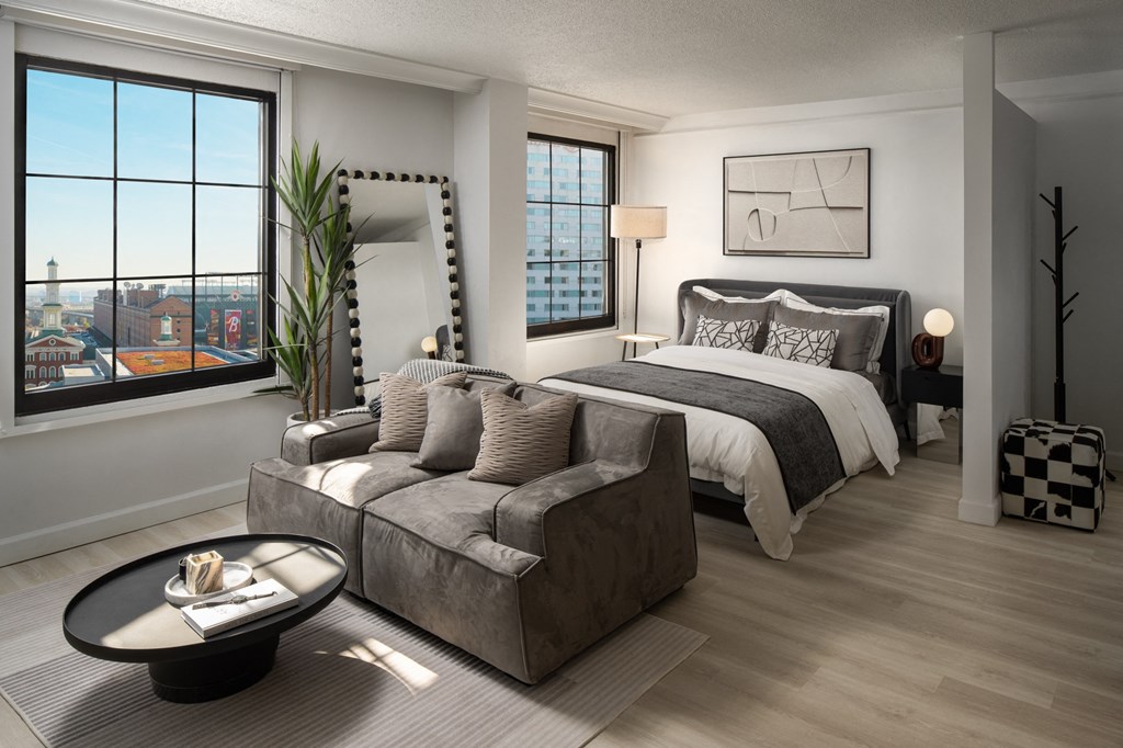 a bedroom with a bed and a couch in a living room at Vision on Lombard, Maryland