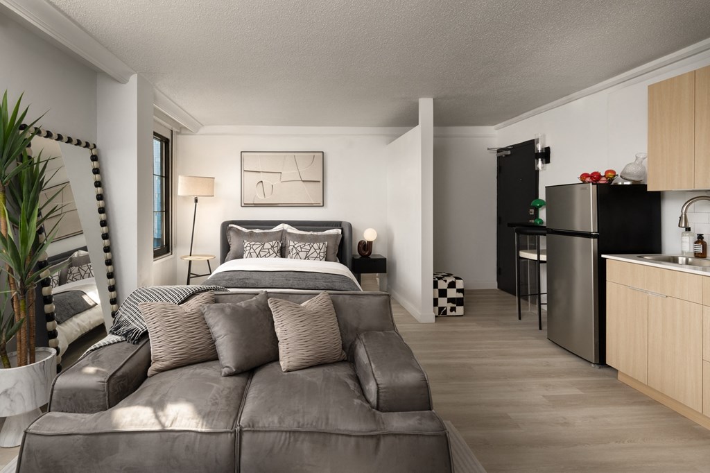 a bedroom with a couch and a bed and a kitchen at Vision on Lombard, Maryland, 21201