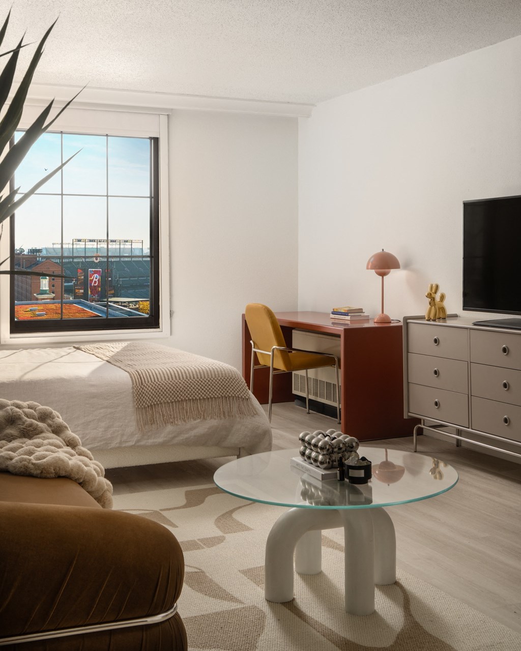 a bedroom with a bed and a desk and a window at Vision on Lombard, Baltimore, MD 21201