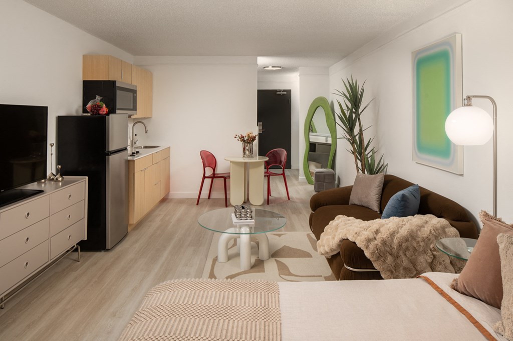 a living room and kitchen with a couch and a table at Vision on Lombard, Baltimore, 21201