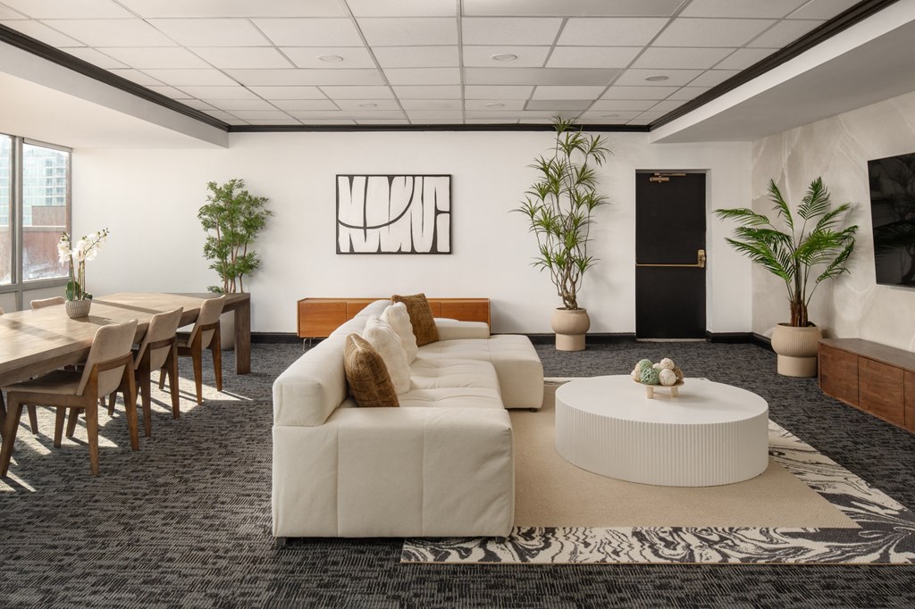 a living room with a white couch and a table at Vision on Lombard, Baltimore