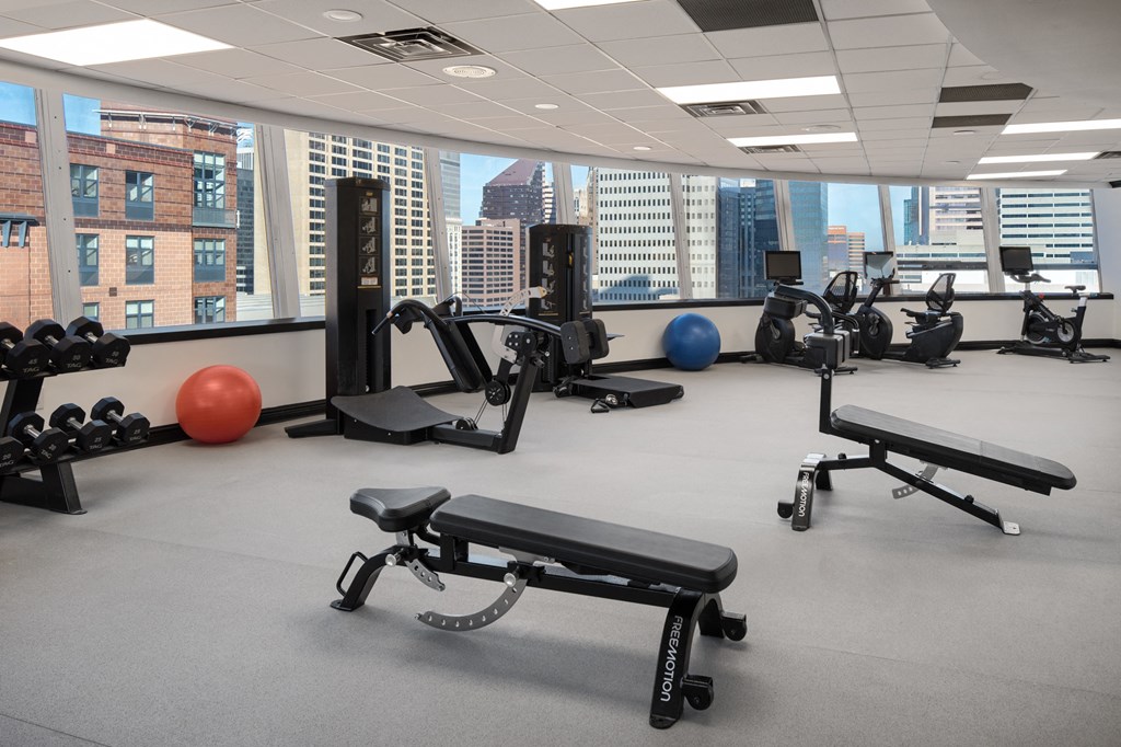 a gym with exercise equipment and a view of the city at Vision on Lombard, Baltimore, MD