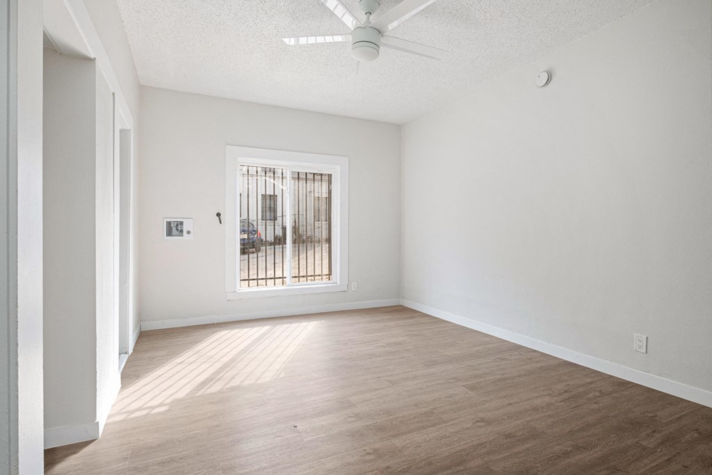 A room with a window and a fan on the ceiling at Hillstone Flats Apartments, Los Angeles