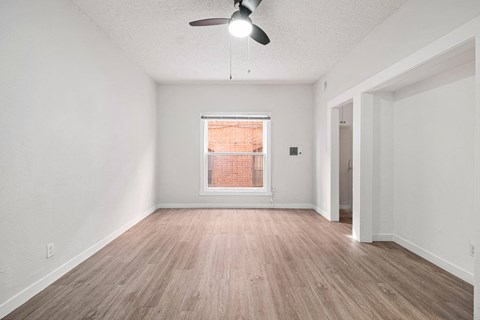 A room with a ceiling fan and a window at Hillstone Flats Apartments, Los Angeles, 90004