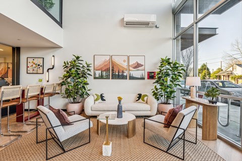 A living room with a white couch and a coffee table.