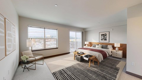 A bedroom with a bed, nightstand, and chair.