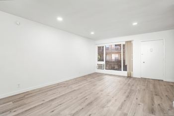 A room with wooden flooring and white walls.at Palms at Menlo, California, 90006