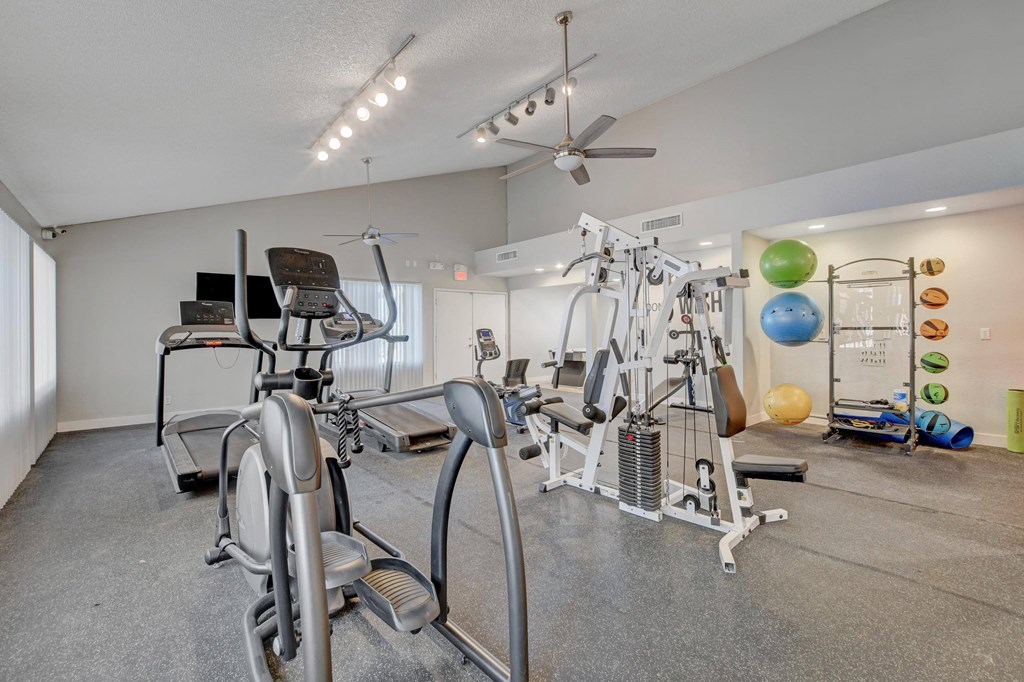 A home gym with a variety of exercise equipment.