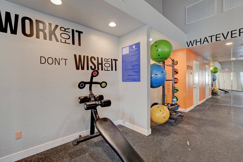 A gym with a wall that says