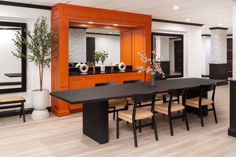 a large dining room with a black table and chairs at Vision on Lombard, Baltimore, MD 21201