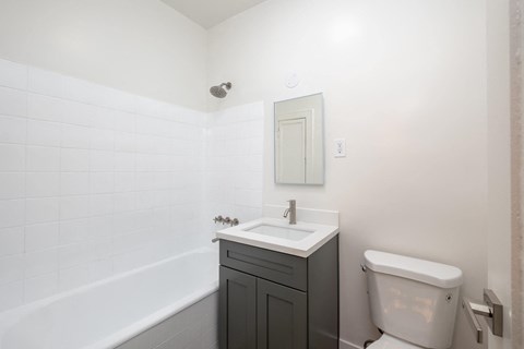 A white sink with a silver faucet and a white toilet in a bathroom at Westmore Manor Apartments, California, 90020