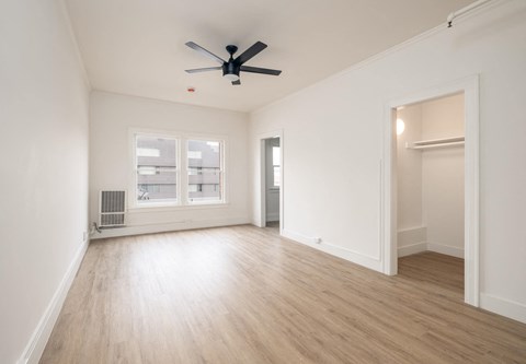 A room with a ceiling fan and a window at Westmore Manor Apartments, Los Angeles, California