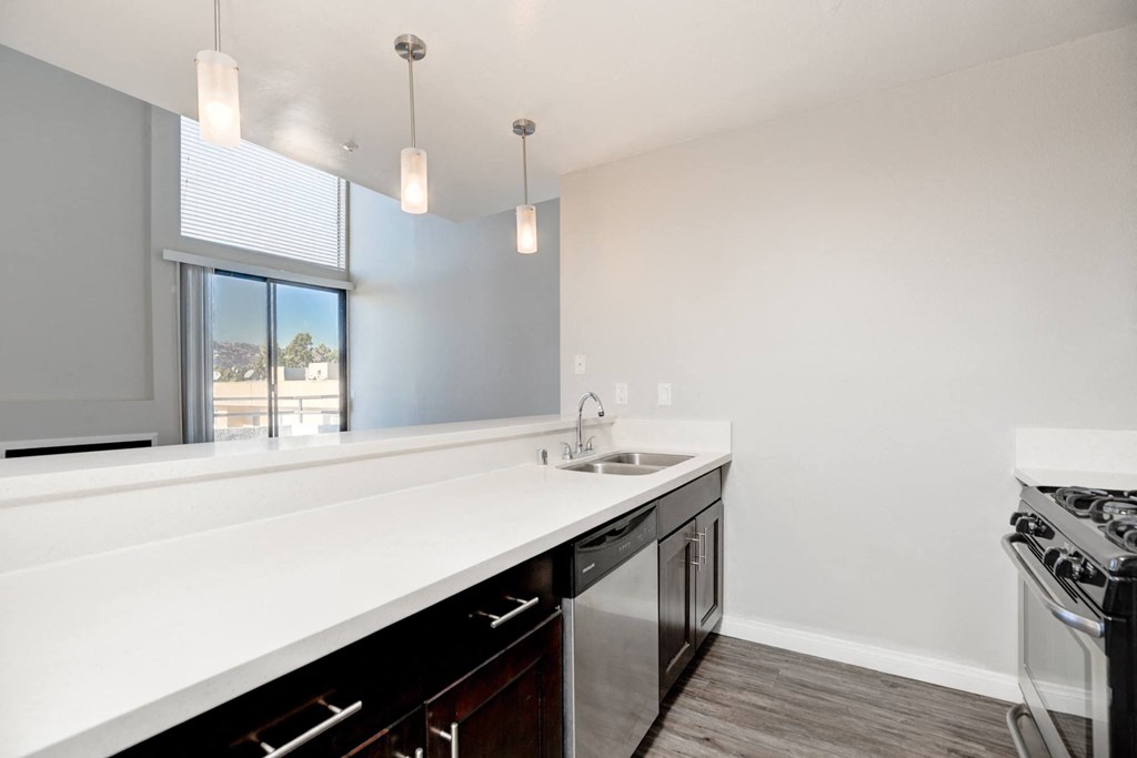a kitchen with an island and a sink and a window