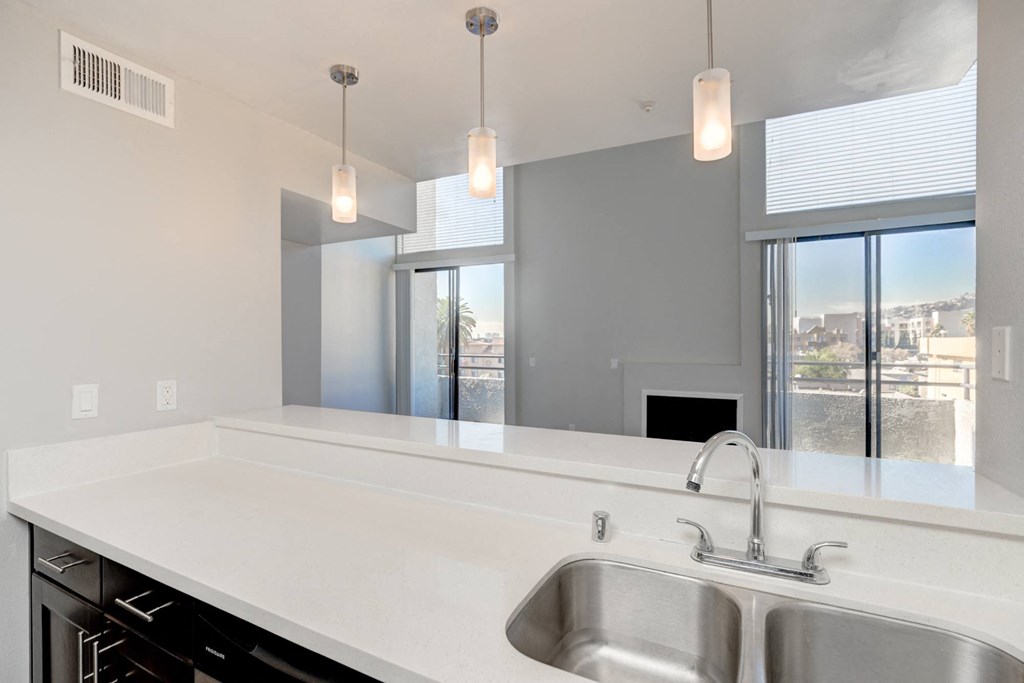 a kitchen with a sink and a large window