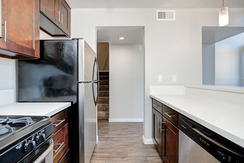 a renovated kitchen with stainless steel appliances and white counter tops