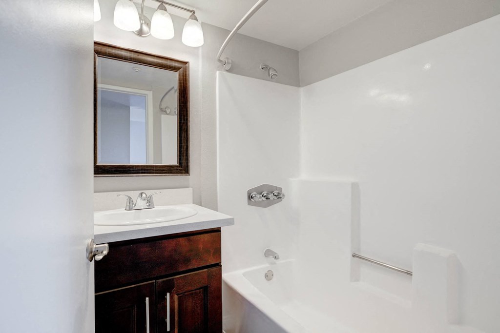 a bathroom with a shower and a sink and a mirror