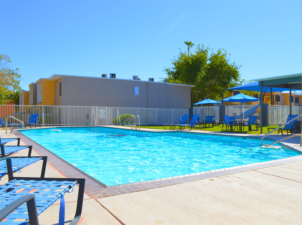 a swimming pool at a hotel with chairs and umbrellasat Summer Meadows, Las Vegas