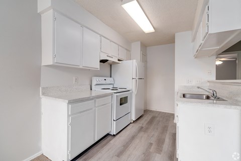 a white kitchen with white appliances and white cabinets at Village Lakes, Orlando, FL, 32808