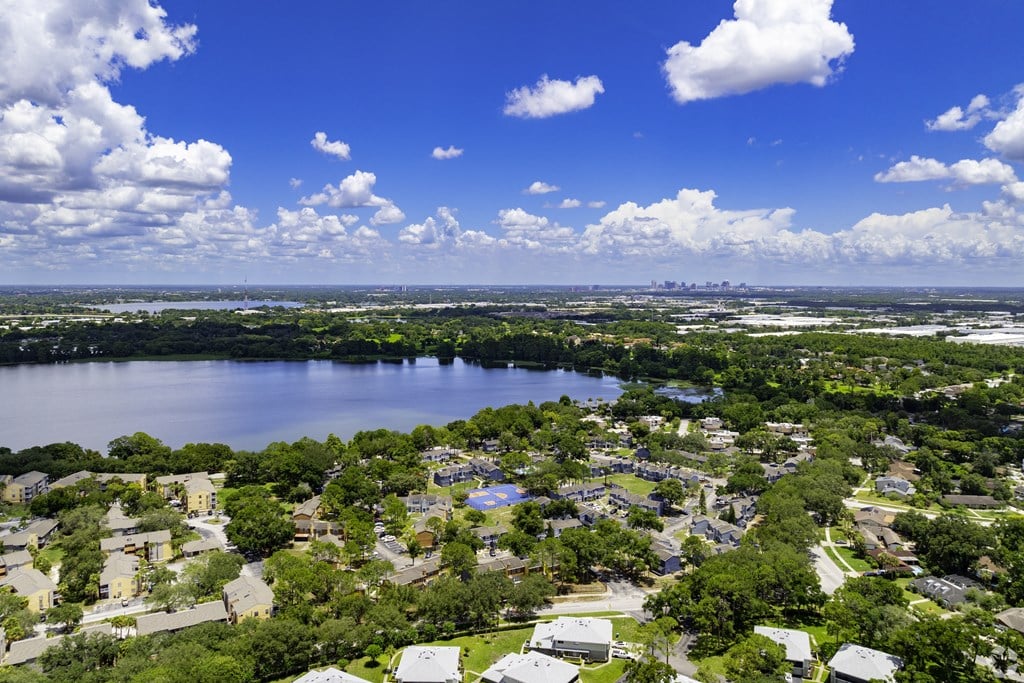 an aerial view of a neighborhood with a lake in the middle
