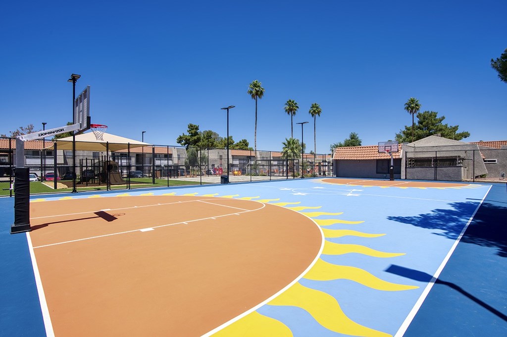 A basketball court with a blue sky in the background.
