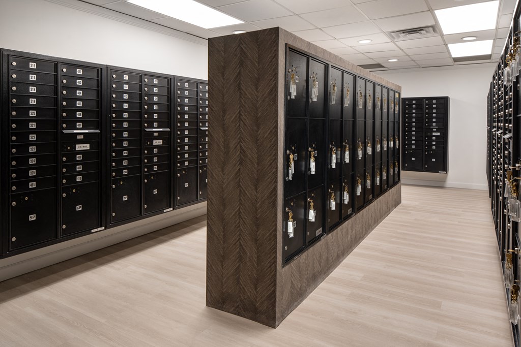 a row of lockers in a room with wood flooring and a white wall at Vision on Lombard, Maryland, 21201