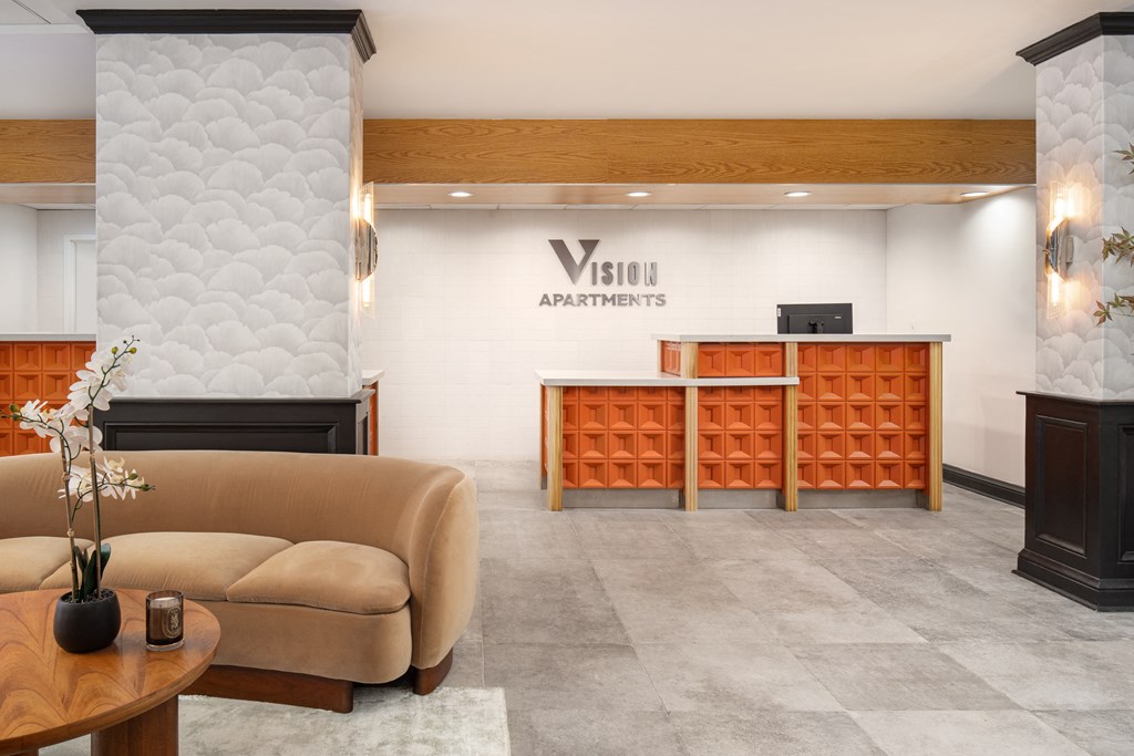 the lobby of a hotel with a reception desk and a couch at Vision on Lombard, Baltimore Maryland