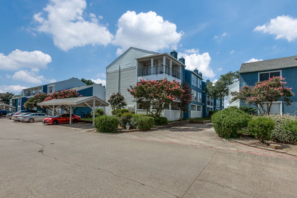 a row of houses with cars parked in front of them at Seacrest Apartments, Texas