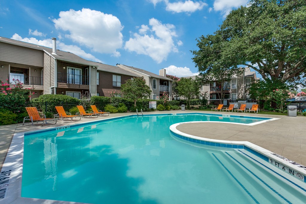 the preserve at ballantyne commons community swimming pool with orange chairs and apartment buildings
