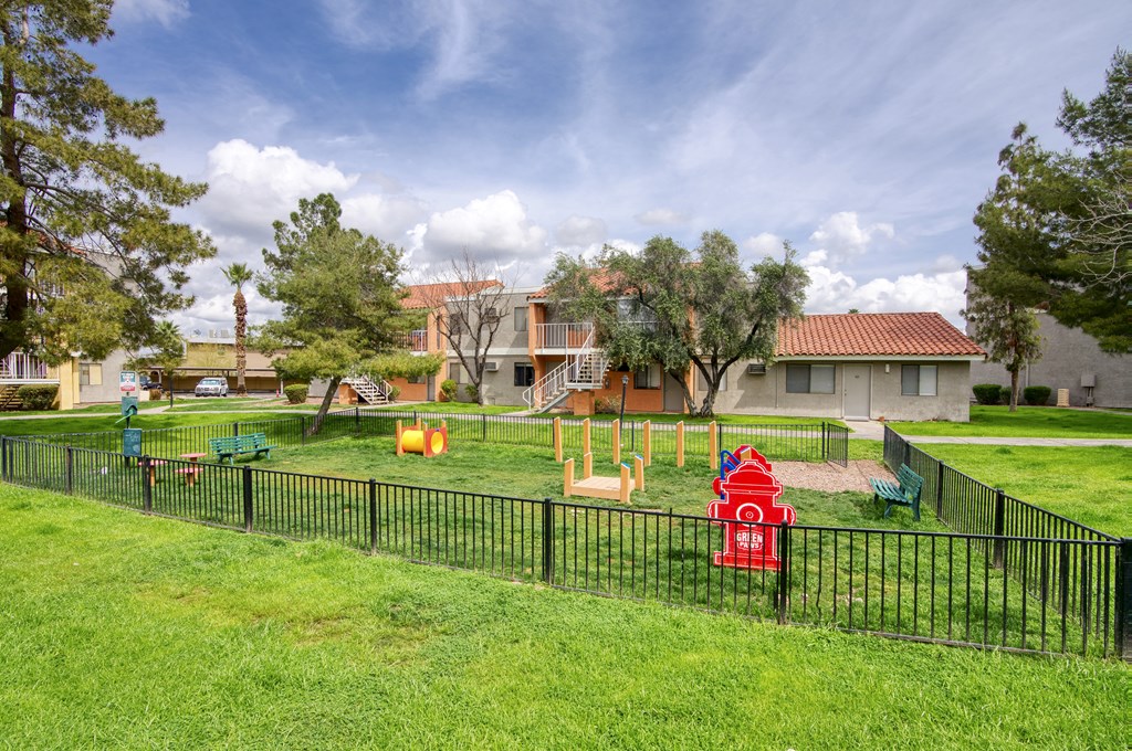 a playground with a fire hydrant in the middle of a grassy area at Valencia Park, Phoenix, Arizona, 85008