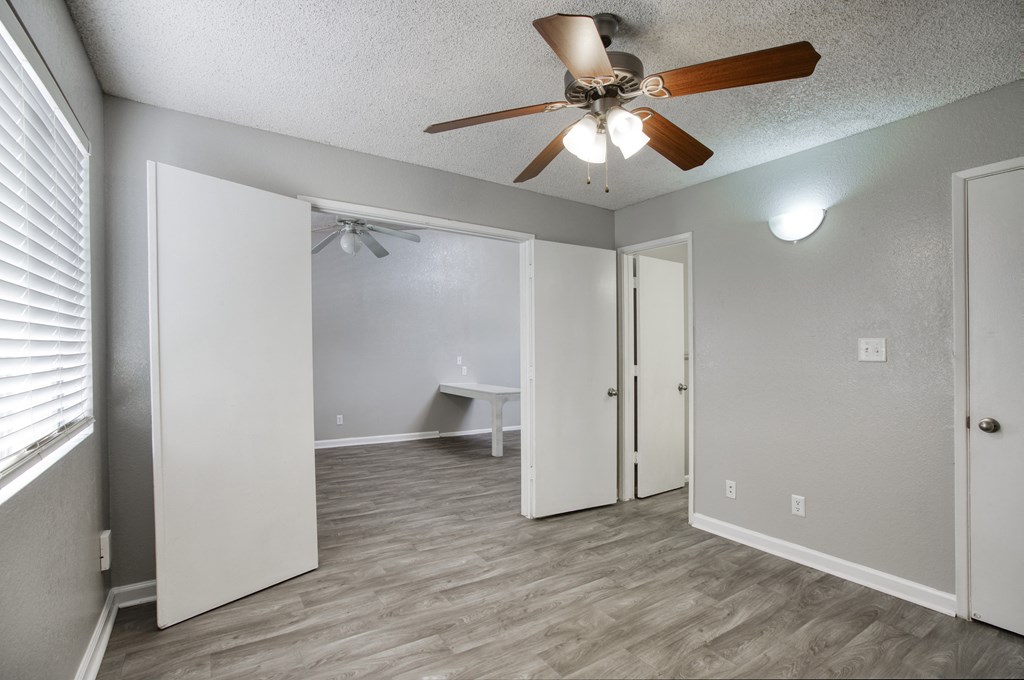 a bedroom with a ceiling fan and a closet at Valencia Park, Phoenix, AZ