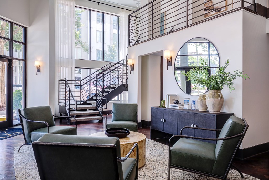 A room with a staircase and a large mirror.