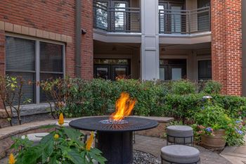 A fire burns in the middle of a patio.