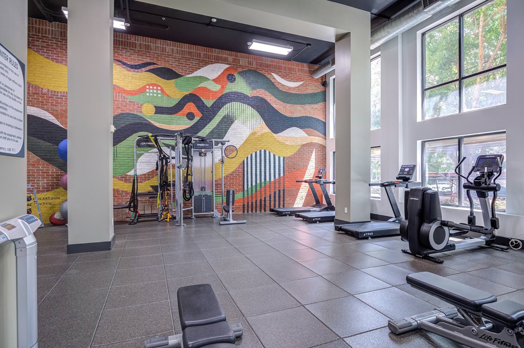 A gym with a colorful mural on the wall.
