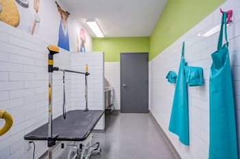 A room with a table and a wall with pictures.