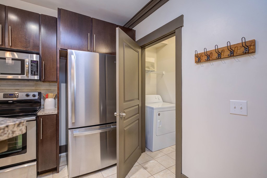 A kitchen with a stainless steel refrigerator and oven.