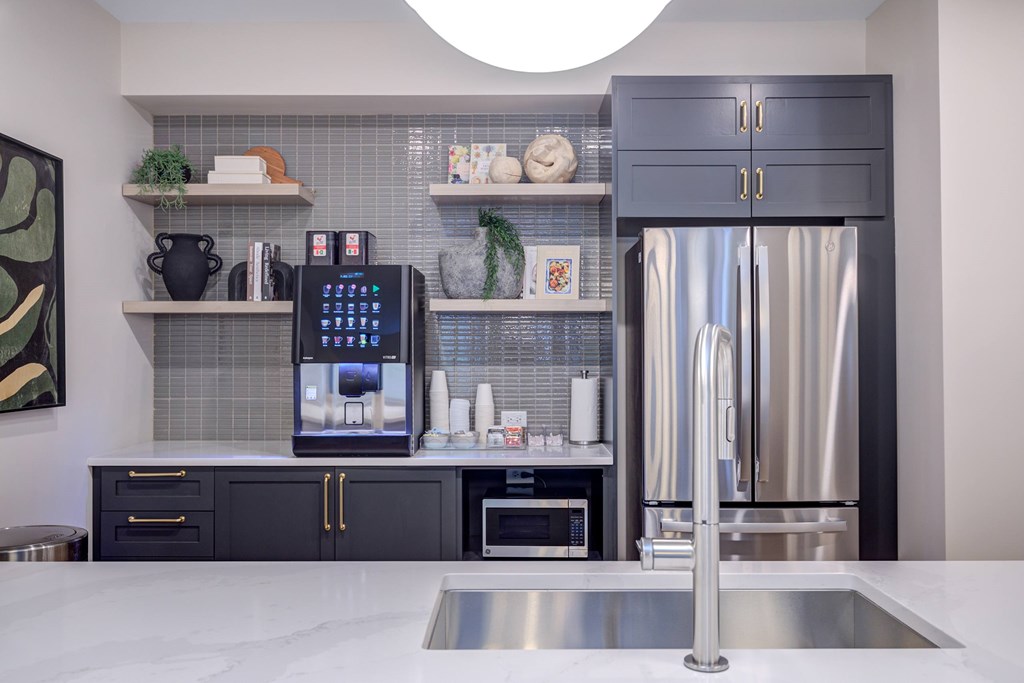 A modern kitchen with a stainless steel refrigerator and a digital ice maker.