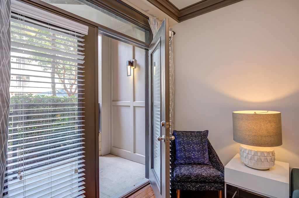 A room with a chair and a lamp.