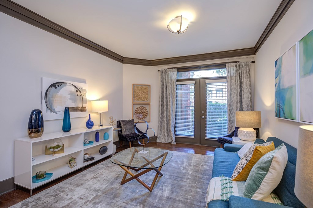A living room with a blue couch and a wooden coffee table.